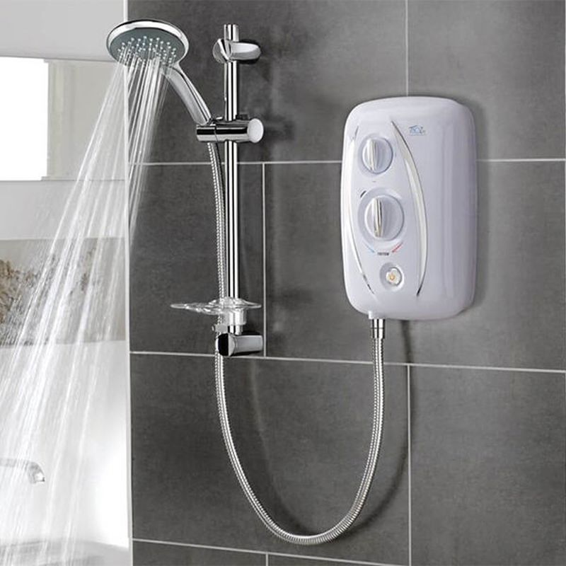 White electric shower unit with chrome riser rail and handheld shower head in use, mounted on dark grey tiled bathroom wall.